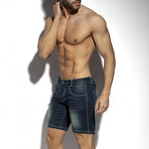 Muscular man wearing ES Collection dark denim Bermuda jean shorts, posing against a plain white background.