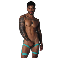 Aqua blue, elastic strappy garter belt with metallic ring accents worn by a tattooed man.