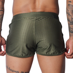 Olive green, athletic-style shorts in breathable mesh fabric with a short hem and slim fit.