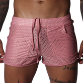 Pink mesh athletic shorts with a drawstring waistband, two side pockets, and a shorter, fitted cut.