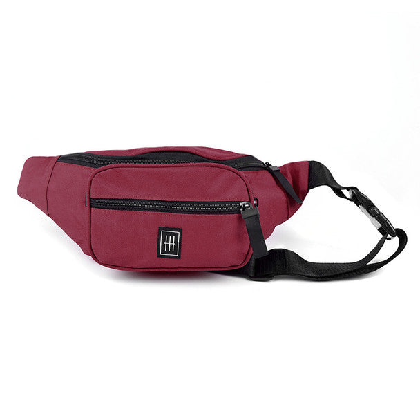 Maroon Westend fanny pack with a black zipper, strap, and a square logo on the front pocket against a white background.