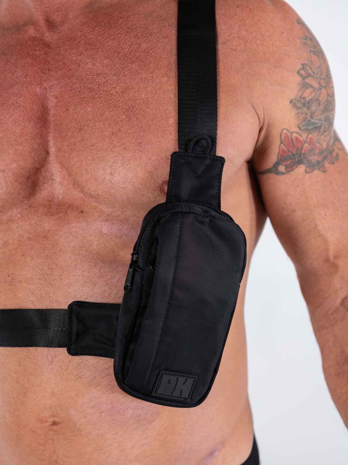 Black nylon fk sport cross body bag with subtle texture and small rectangular logo patch on front