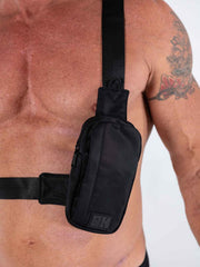 Black nylon fk sport cross body bag with subtle texture and small rectangular logo patch on front