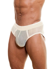 Close-up of a model wearing champagne-colored Full Kit Gear Captivity Brief underwear made of open mesh material.