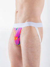 Side view of a person wearing a jockstrap with a psychedelic pink, orange, and blue mesh pouch and a white waistband.