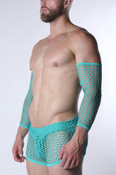 A bearded man wearing turquoise fishnet arm sleeves and matching briefs against a white background.