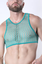 A man wearing a turquoise CellBlock 13 Vaux Galaxy mesh cropped tank top against a white background.