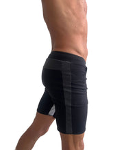 Black tri-color ultra-flex yoga track shorts with ribbed waistband and dark gray vertical stripes on sides