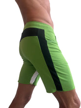 Vibrant lime green tri-color ultra-flex yoga track shorts with bold black and white side panels for athletic use