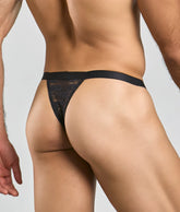 Black lace thong with solid waistband by MOB Y featuring delicate lace material and minimal coverage for sexy appeal