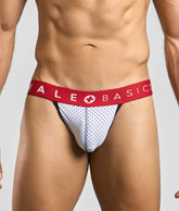 Malebasics spot jockstrap in white mesh briefs with red waistband and male basics logo with white cross symbol