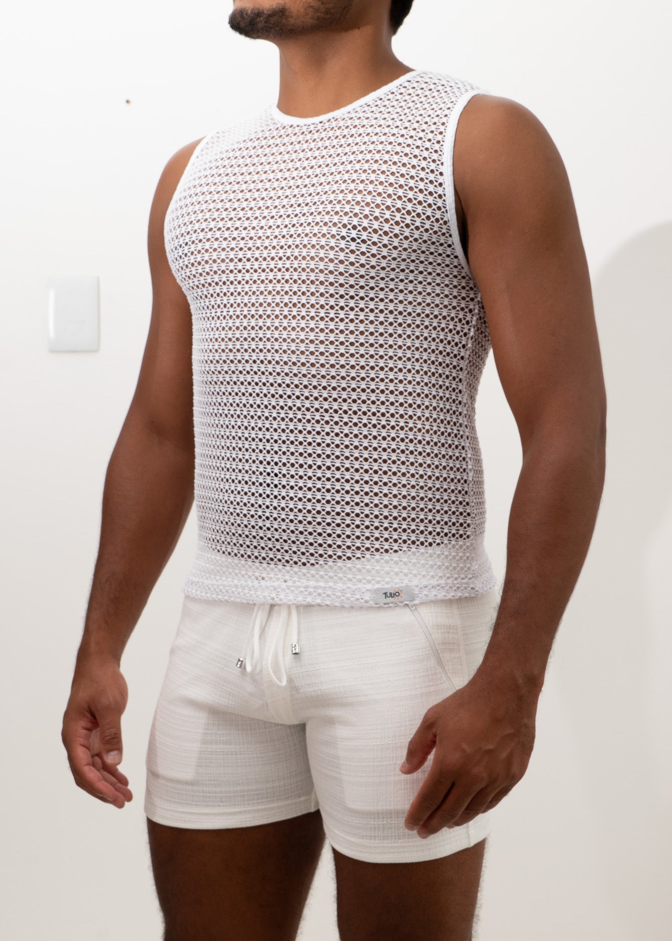 White crochet muscle tank top with sleeveless design mesh texture and round neckline for casual wear