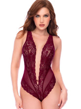 Woman in a rich burgundy lace teddy with a deep V-neck.