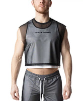 Man wearing a black mesh crop top tank over a white layer, paired with grey drawstring shorts.