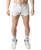 A model wearing Nasty Pig Duke bleached denim shorts with frayed hems and longer pocket linings hanging below the cuffs.