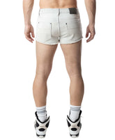 Rear view of a man wearing bleached Nasty Pig Duke Shorts, white socks, and sneakers.