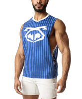 A muscular man wears a blue and white pinstripe sleeveless shirt with a large logo on the chest and white denim shorts.