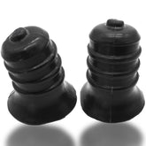 Two black silicone OXBALLS Ribnips novelty items with ribbed designs and flared bases against a white background.