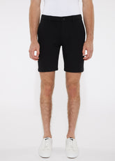 Black tailored chino shorts in solid stretch knit with sleek modern cut and subtle stitching details