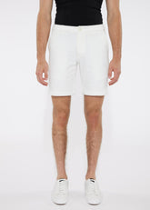 White solid stretch knit shorts with a tailored fit and subtle side pockets made from cotton material