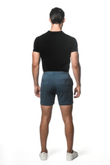 Dark teal textured stretch knit chino shorts with subtle gradient fade and two back pockets shown from the back