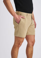 POSTMARC khaki stretch knit chino shorts worn with a black t-shirt against a light gray background.
