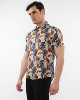 Lightweight linen tencel short sleeve shirt with vibrant navy blue burnt orange and cream tropical leaf pattern on beige