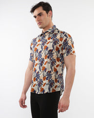Lightweight linen tencel short sleeve shirt with vibrant navy blue burnt orange and cream tropical leaf pattern on beige