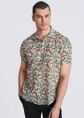 A male model wearing a POSTMARC short-sleeve button-down shirt with an orange and teal fruit print.