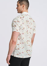 Man wearing white short-sleeve button-down shirt with merlot and yellow vine pattern, viewed from the side and back.
