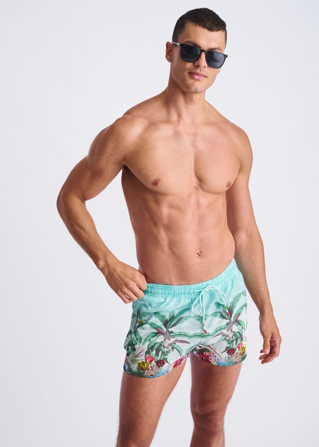 Men’s turquoise tropics print swim shorts with palm tree and fruit design and mesh lining for comfortable wear
