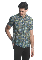 A men’s short-sleeved cotton silk shirt with a vibrant blue green yellow circle pattern on dark fabric
