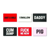 Six rectangular silicone badges with bold text including Just a Hole, I Swallow, Daddy, Cum Dump, Fuck Me Now, and Pig.