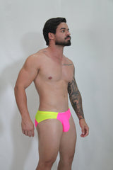 Neon curved swim brief featuring vibrant neon yellow and pink two-tone fabric with a bold modern design