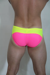 Neon curved swim brief features vibrant neon pink and lime green colors with a sleek form-fitting design for swimming