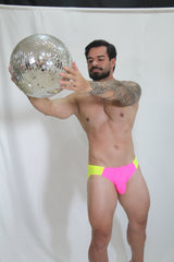 Shiny silver disco ball with mirrored facets reflecting light for vibrant neon curved swim brief display