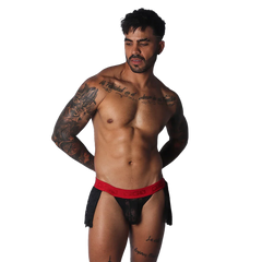 Black lace skirt with a bold red, branded elastic waistband worn by a muscular man.