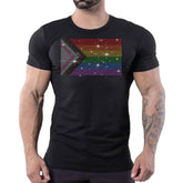 Black crewneck t-shirt featuring a sparkling rhinestone Progressive Pride flag on the chest, worn by a man.
