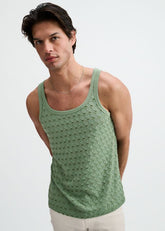 A model wears a cactus green ST33LE stretch ripped knit tank top against a plain white background.