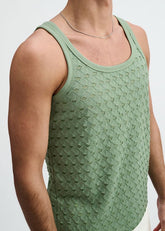 A man wearing a green ST33LE stretch ripped knit tank top in cactus.