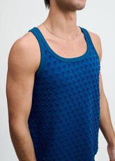 A man wearing a ST33LE petrol blue stretch ripped knit tank top with a textured pattern.