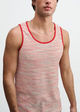 A male model wearing a ST33LE poppy space dye textured knit tank top with red trim against a white background.