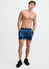 A shirtless man models ST33LE blue and navy abstract print mesh gym shorts against a plain white background.