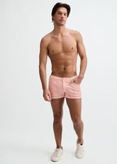 Shirtless man wearing ST33LE 3 stretch knit tweed look jacquard shorts in parfait pink against a white background.