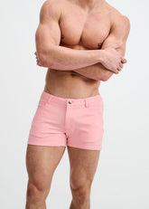 A shirtless man wearing pink ST33LE 3 stretch knit shorts with front pockets against a white background.