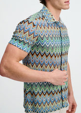 A man wearing a ST33LE short-sleeve button-down shirt with a blue, brown, and green chevron open knit pattern.