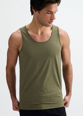 A man wearing an army green textured stretch mesh performance tank top by ST33LE against a plain white background.