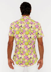A fruits print stretch knit shirt with lime and pink citrus slices on a dark navy background in a short sleeve design