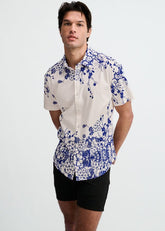 A male model wearing a ST33LE short-sleeve button-down shirt with a navy and white floral engineered border print.