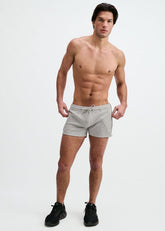 Shirtless man wearing grey ST33LE 3.5 stretch gym shorts with contrast piping and a drawstring.
